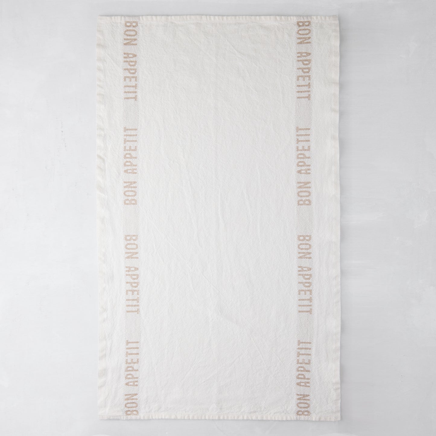 Khaki "Bon Appetit" linen hand towel, 25.7"L x 17"W, with "Bon Appetit" text on vertical borders.