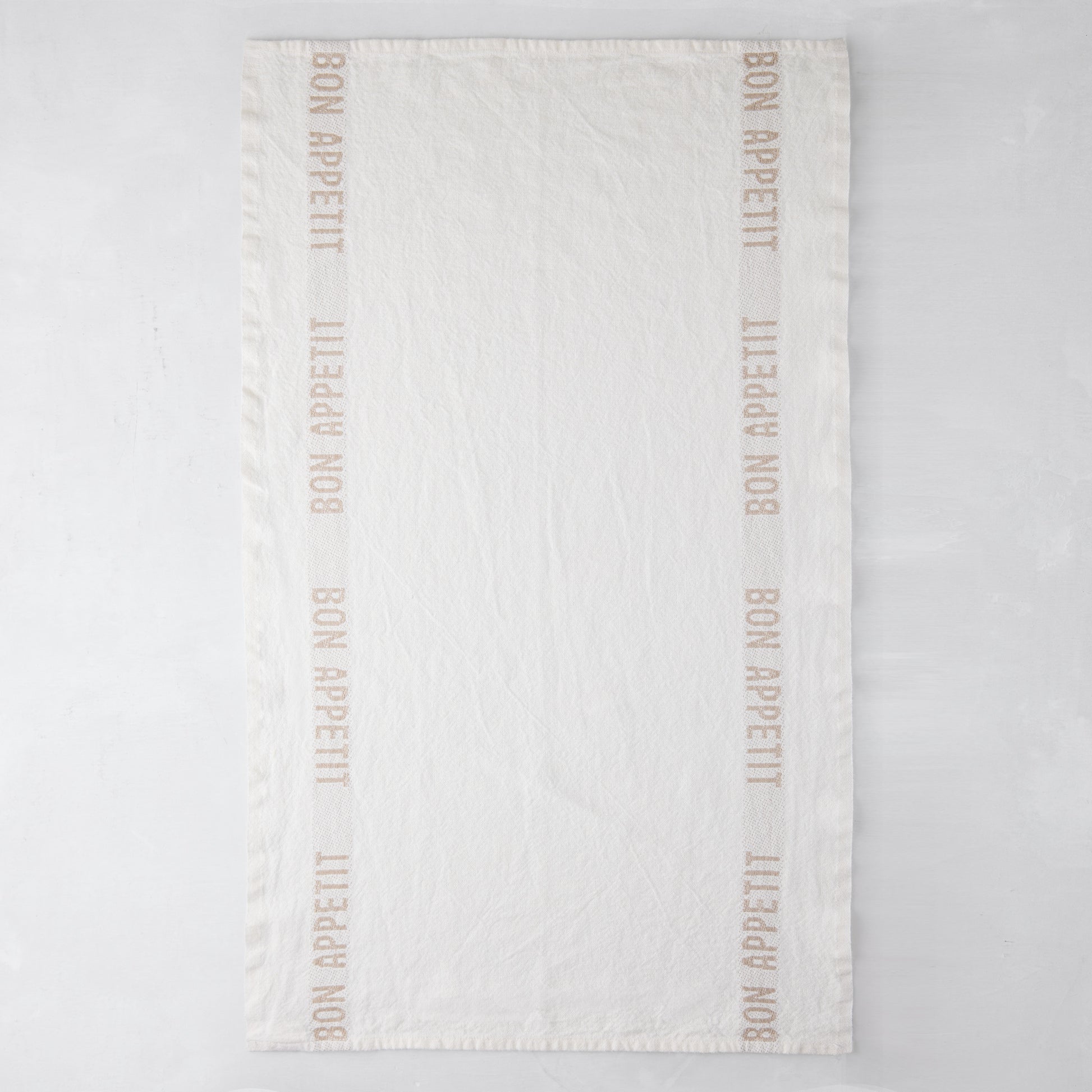 Khaki "Bon Appetit" linen hand towel, 25.7"L x 17"W, with "Bon Appetit" text on vertical borders.