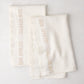 Set of 2 khaki linen hand towels with "BON APPETIT" text, folded on a white surface.