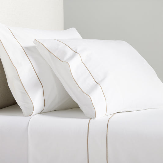 White percale sheet set with khaki satin stitch border on pillowcases and flat sheet.