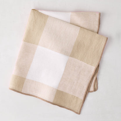 Khaki buffalo check linen napkin, 20x20, folded on a white surface.
