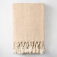 Khaki chevron cotton throw blanket with thick rope fringe.