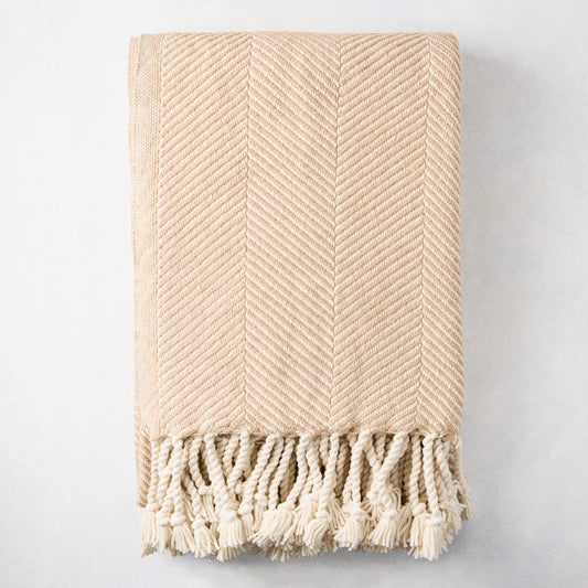 Khaki chevron cotton throw blanket with thick rope fringe.