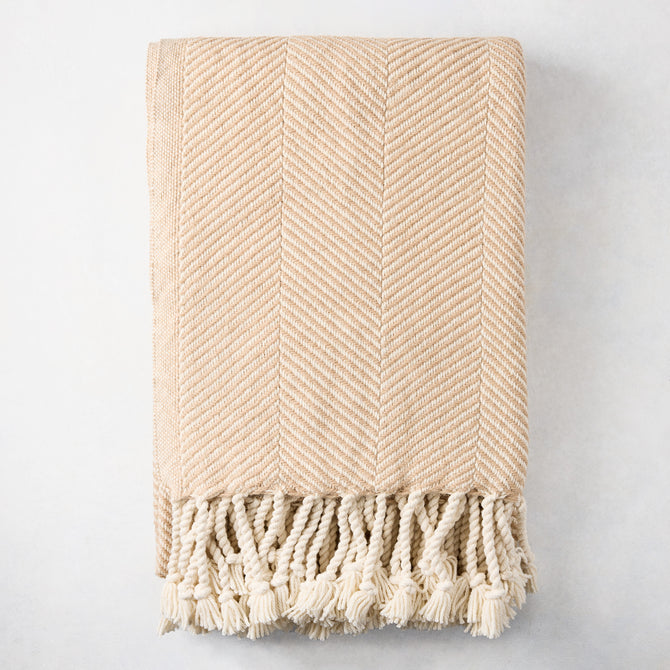Khaki chevron cotton throw blanket with thick rope fringe.