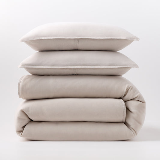 Stacked khaki European washed linen duvet and two matching pillow shams on a white background.