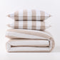 Khaki and white wide-striped duvet cover folded with two matching rectangular pillow shams stacked on top.