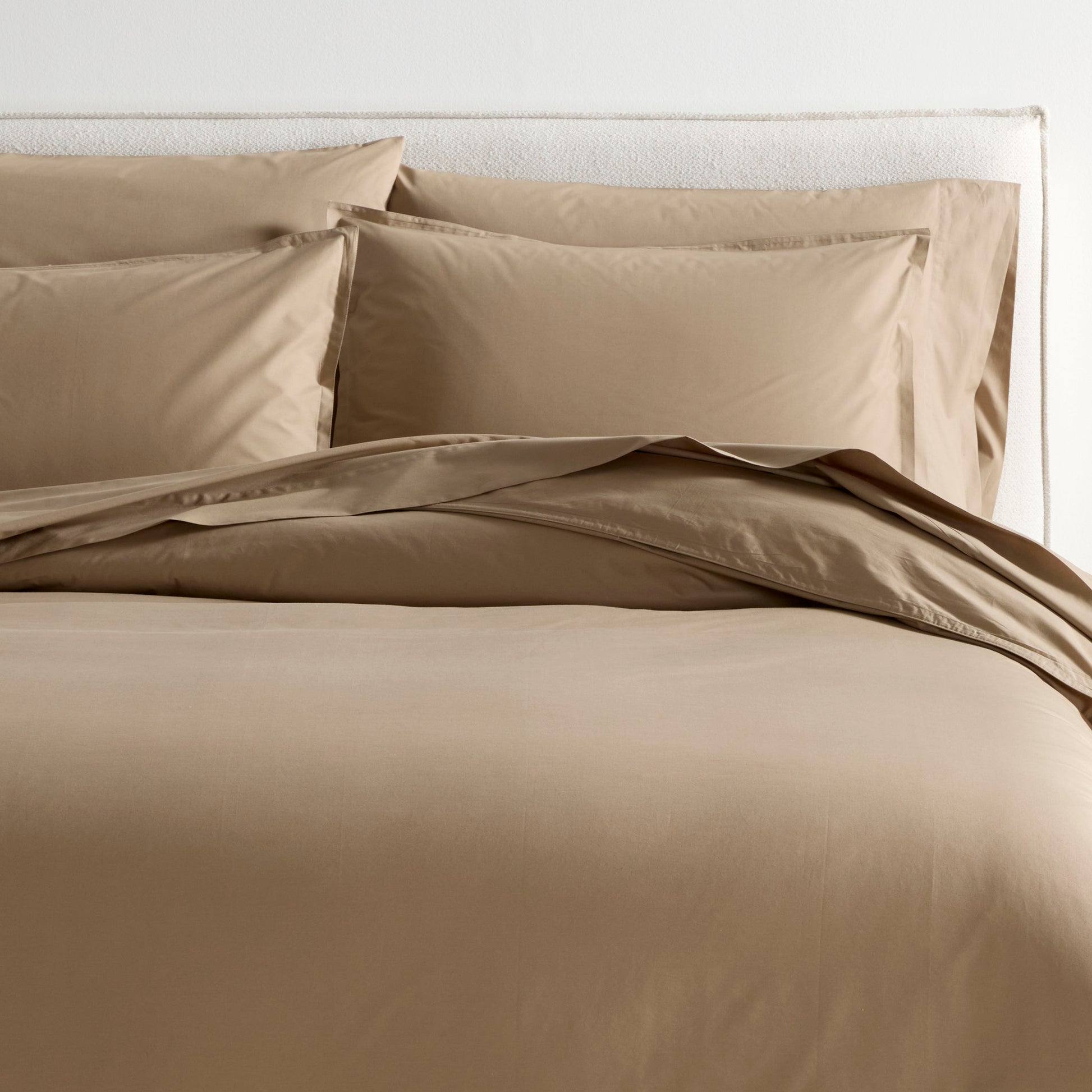 Khaki Italian Percale Duvet Set with duvet cover and two shams on a bed.