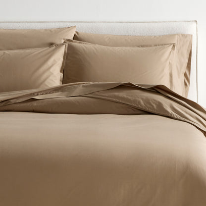 Khaki Italian Percale Duvet Set with duvet cover and two shams on a bed.