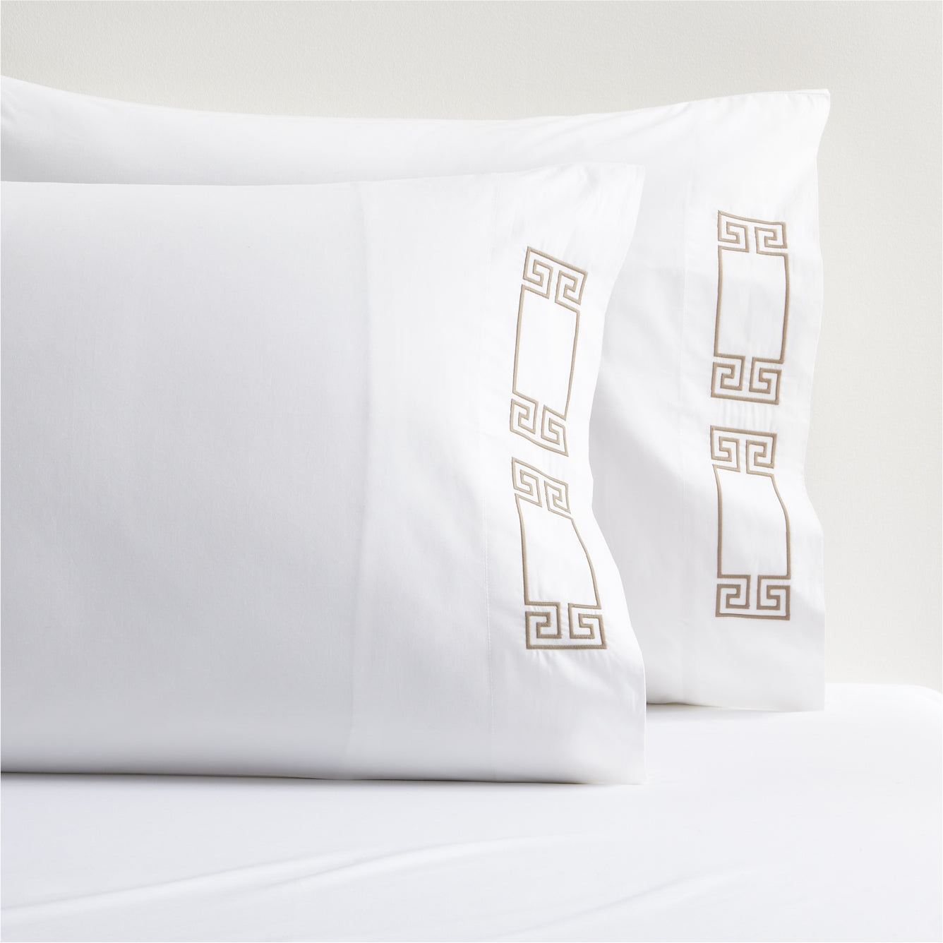 White percale pillowcases with Khaki embroidered Greek key design.