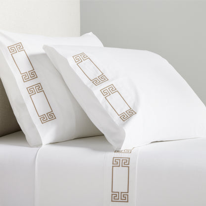 White percale sheet set with khaki embroidered Greek key border on pillows and flat sheet.