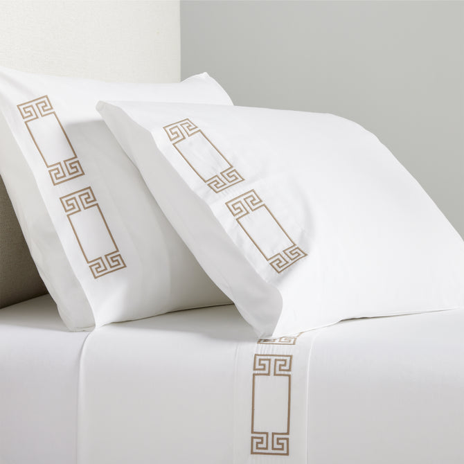 White percale sheet set with khaki embroidered Greek key border on pillows and flat sheet.