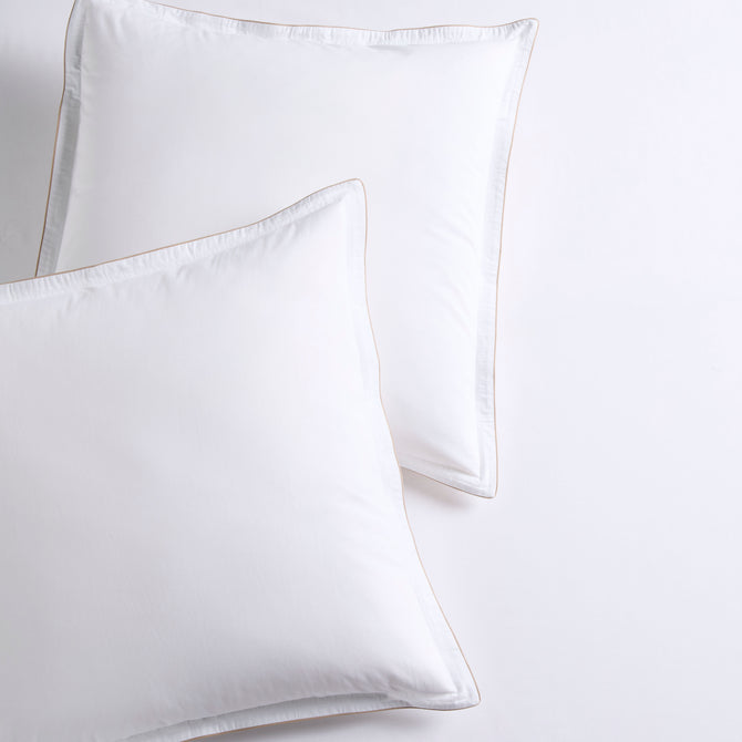 Set of 2 white percale Euro shams with khaki piping and double-stitch detailing.