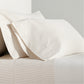 Khaki Stripe Cotton-Chambray Sheet Set with thin woven stripes on pillows and flat sheet.