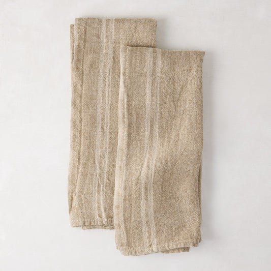 Set of 2 khaki striped French linen hand towels, folded on a white surface.