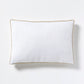 White linen lumbar pillow with khaki velvet gusseted trim.