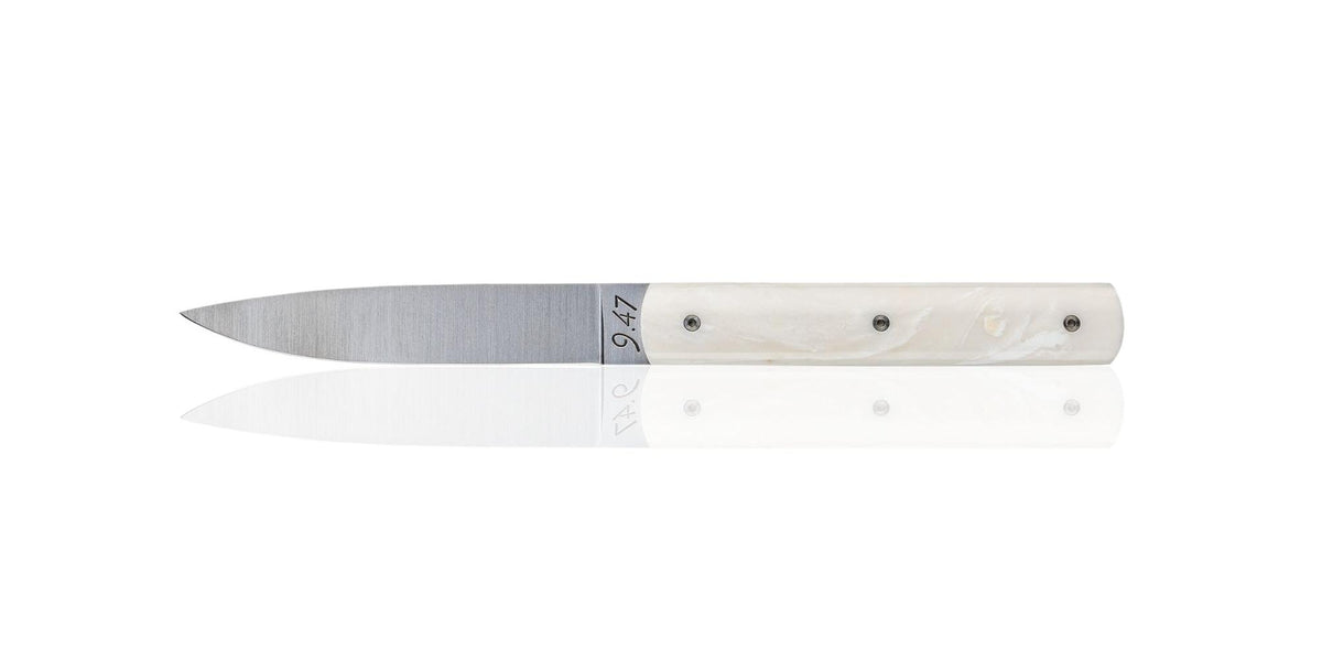 Perceval 9.47 stainless steel table knife with a sleek coffee creme Krion handle, 8.5 inches long.