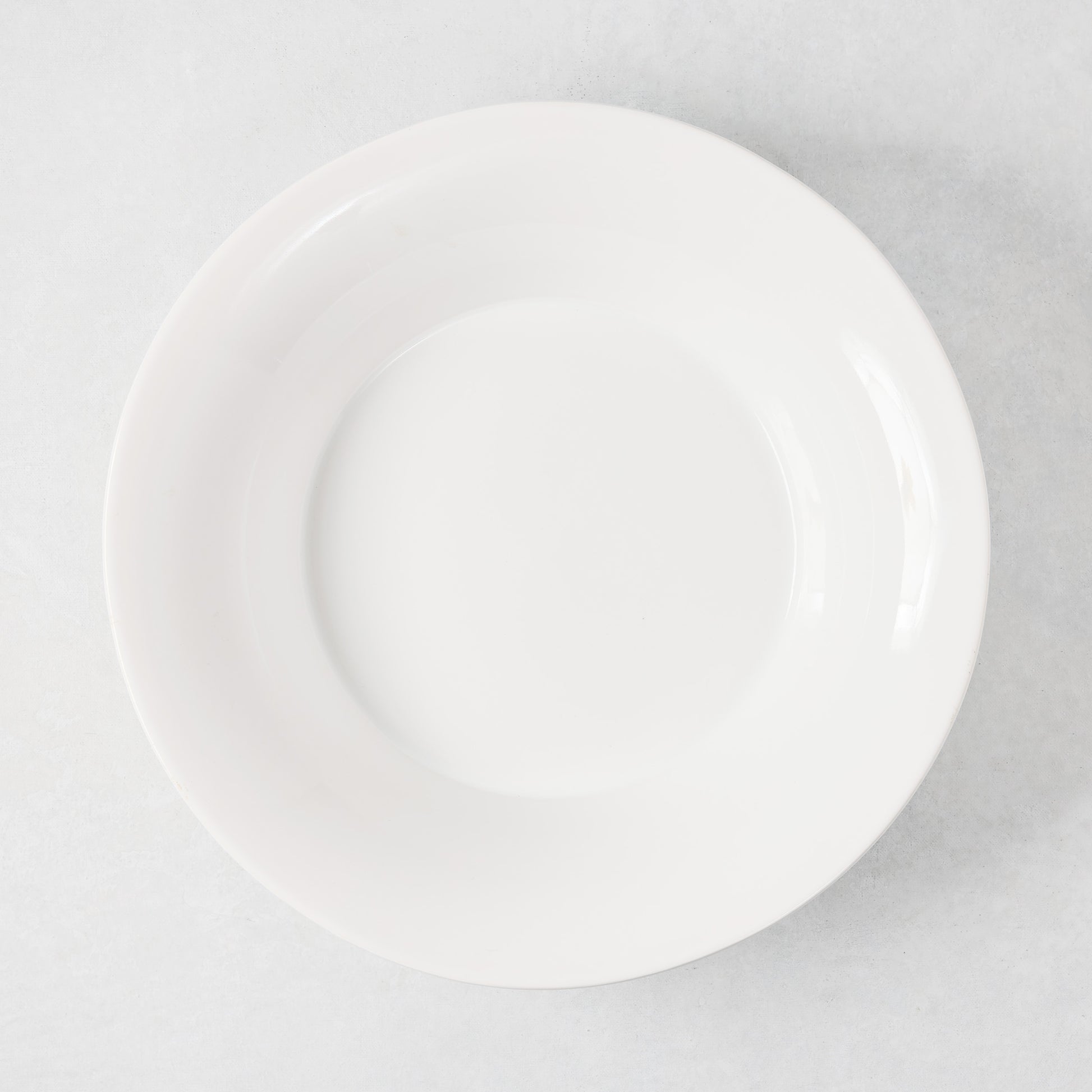 White ceramic Lagos serve bowl with a flared edge.