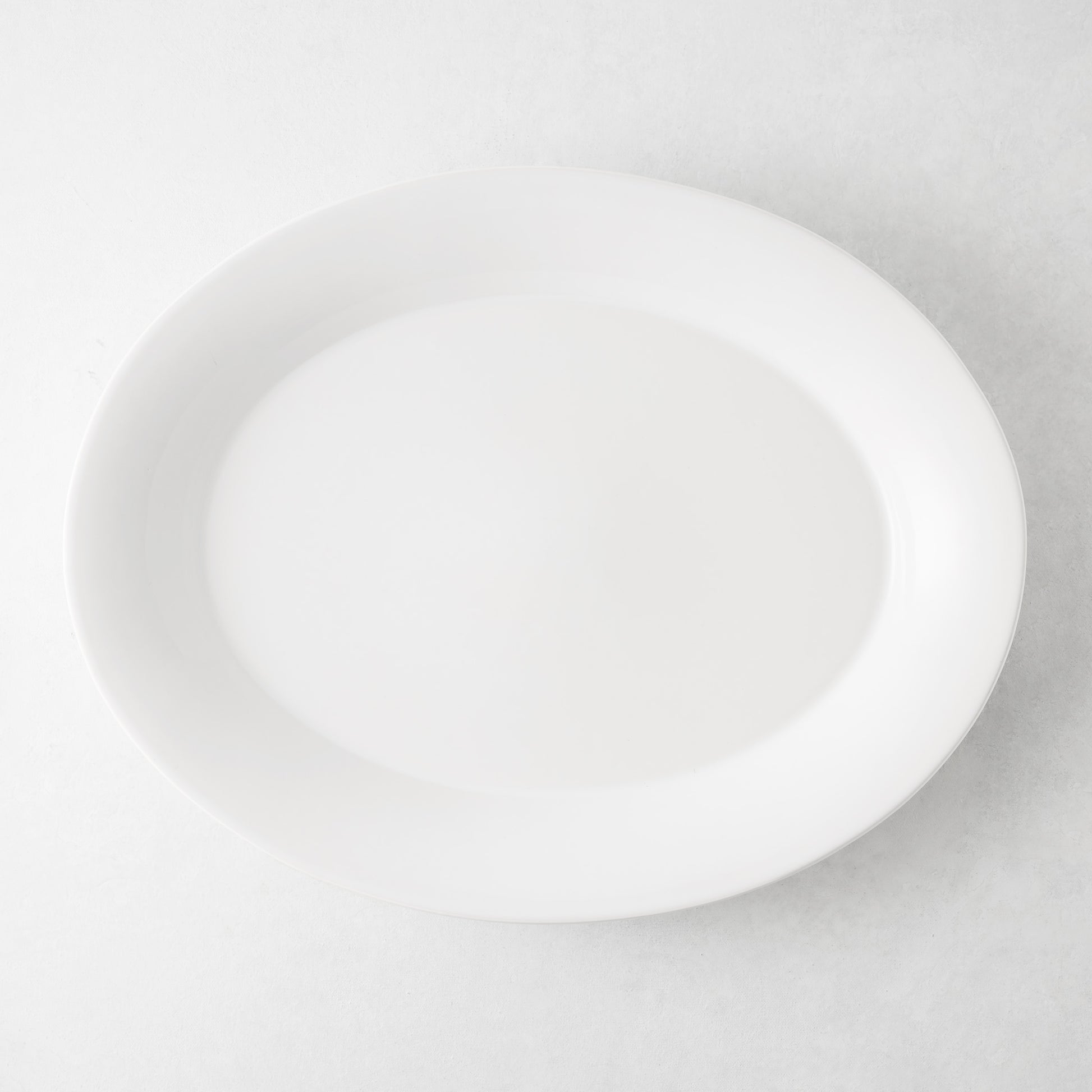 Lagos Large Ceramic Serving Platter, white oval, 18"L x 14"W, with raised edge.