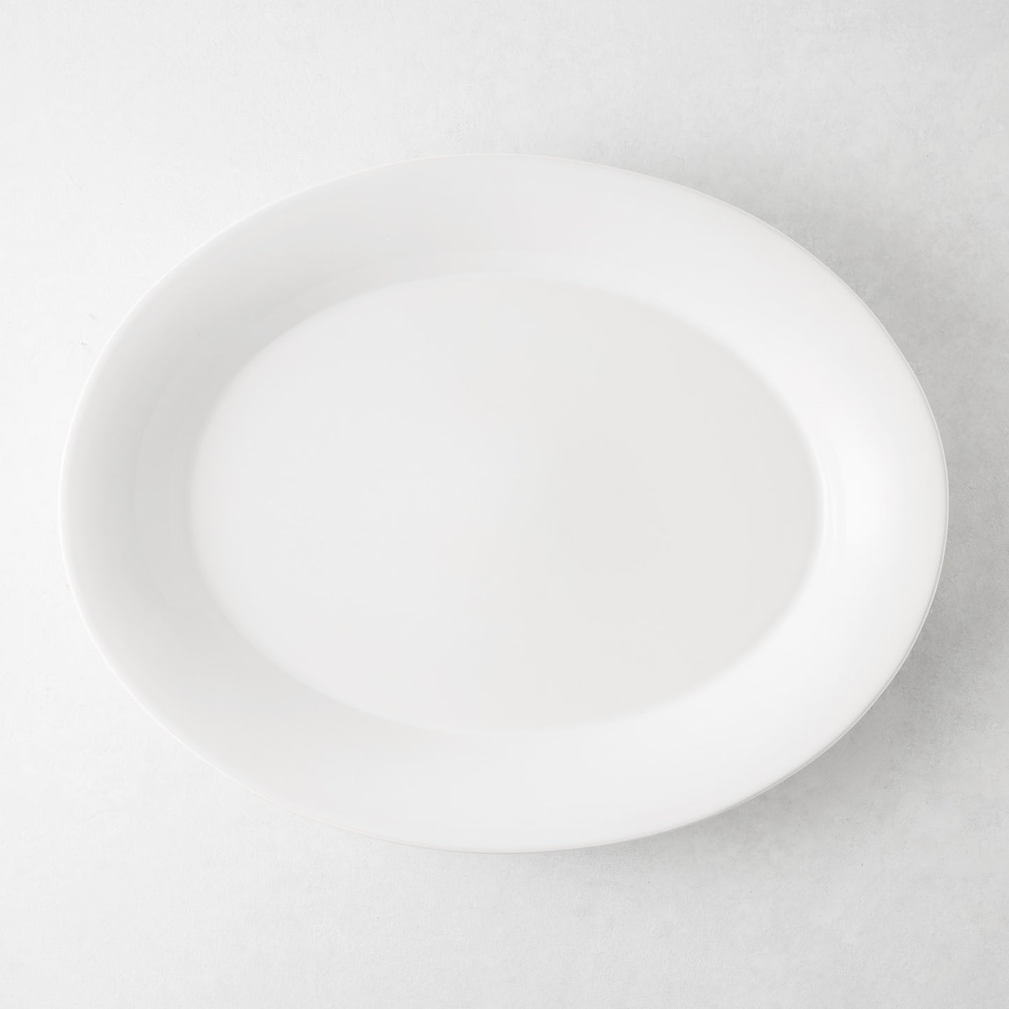 Lagos Large Ceramic Serving Platter, white oval, 18"L x 14"W, with raised edge.