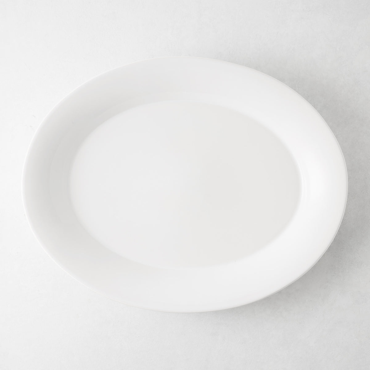 Lagos Large Ceramic Serving Platter, white oval, 18"L x 14"W, with raised edge.