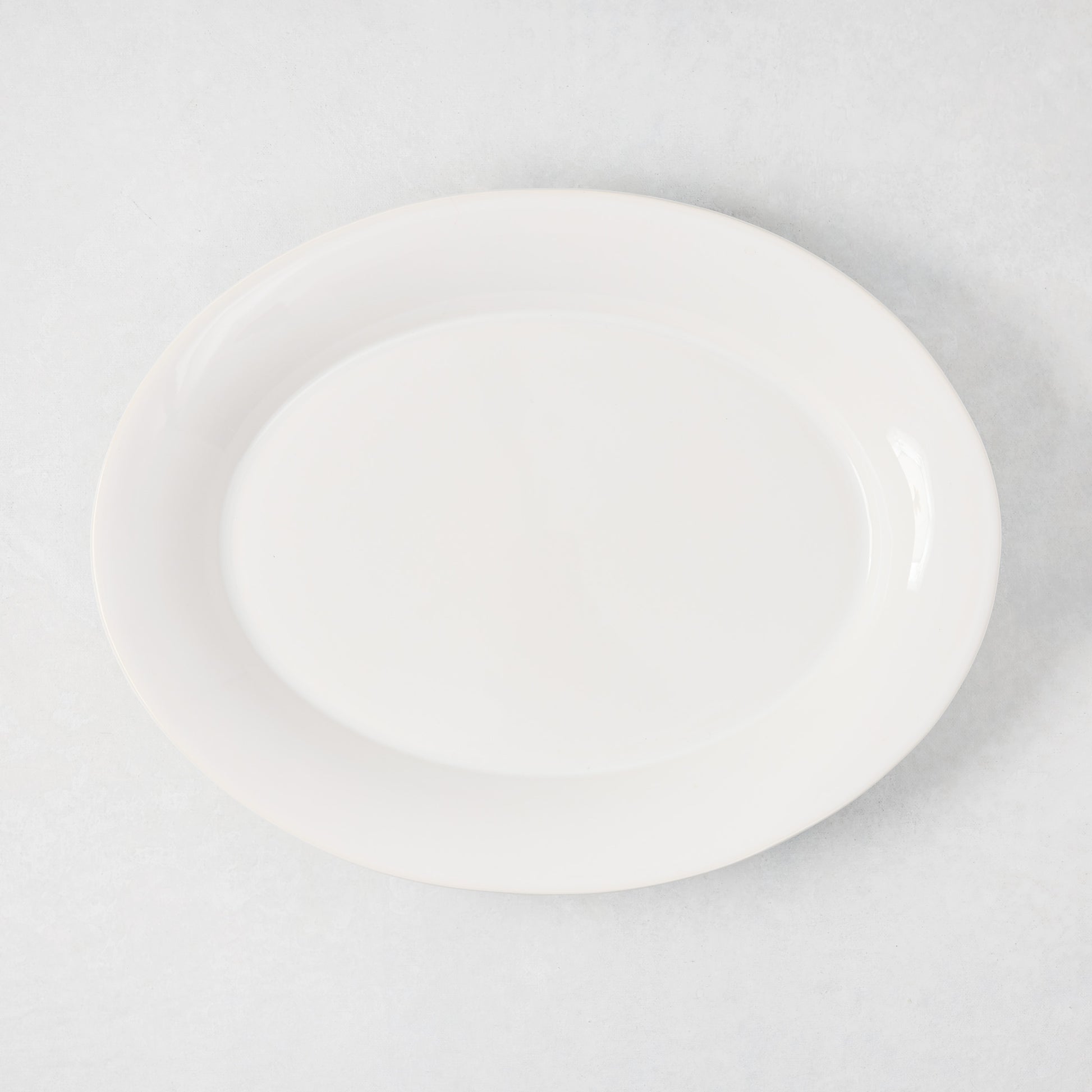 Lagos Small Ceramic Serving Platter, white oval with raised edge, 15.75"L x 12.4"W.