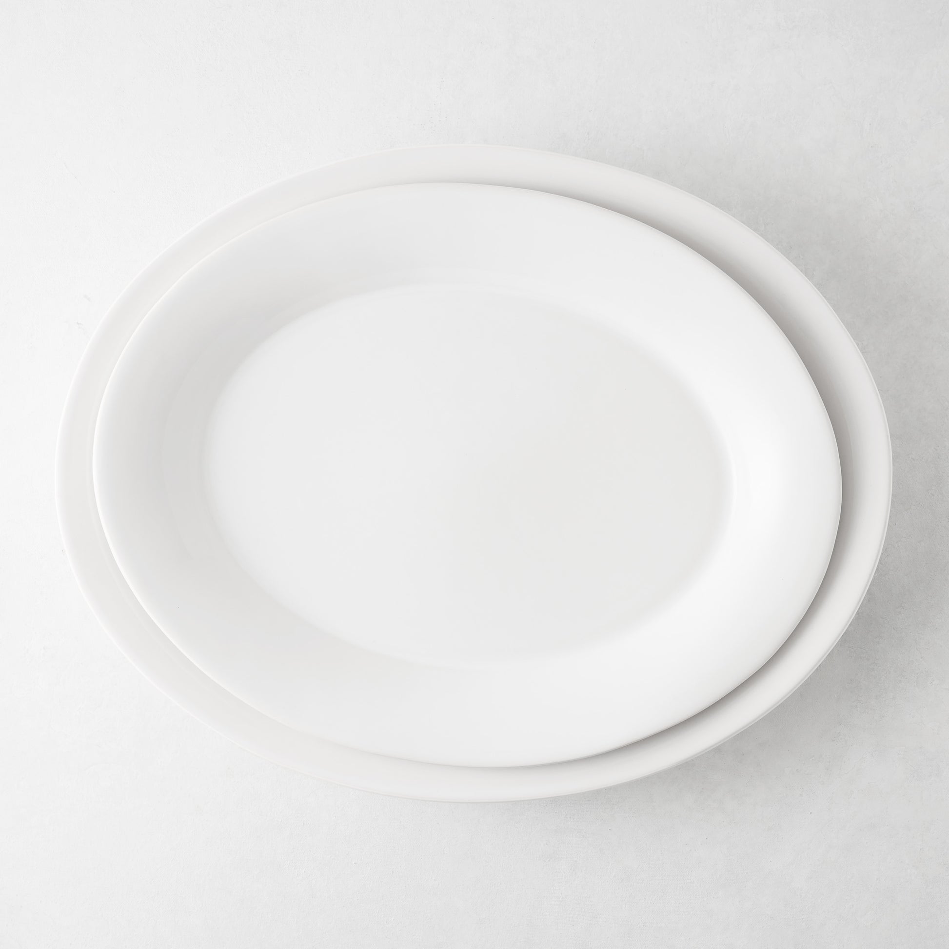 Lagos Small Ceramic Serving Platter, white oval, 15.75"L x 12.4"W, with a slightly raised edge.