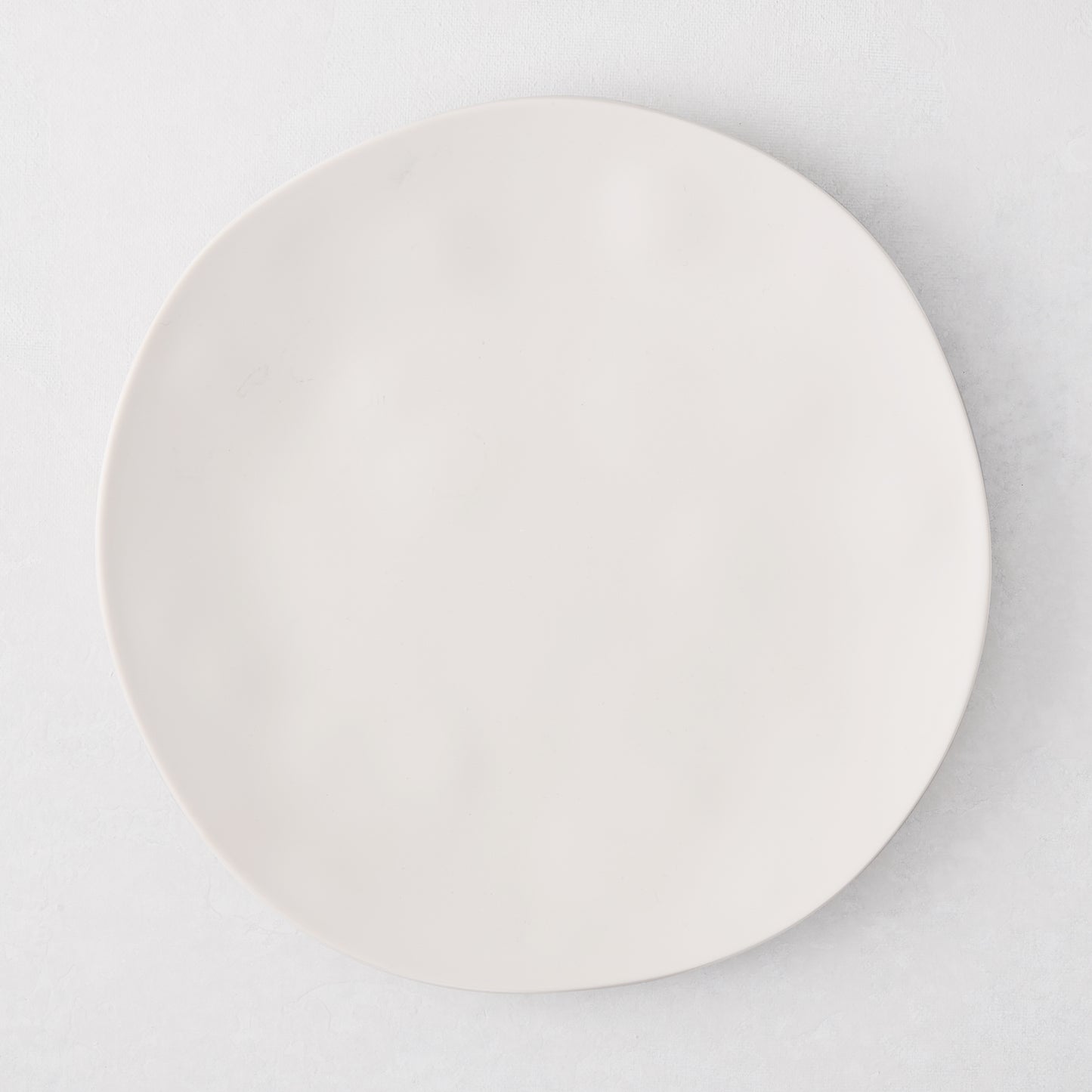 Laguna Melamine Appetizer Plate, off-white, 6.8"Dia, round, with subtle wavy edge.