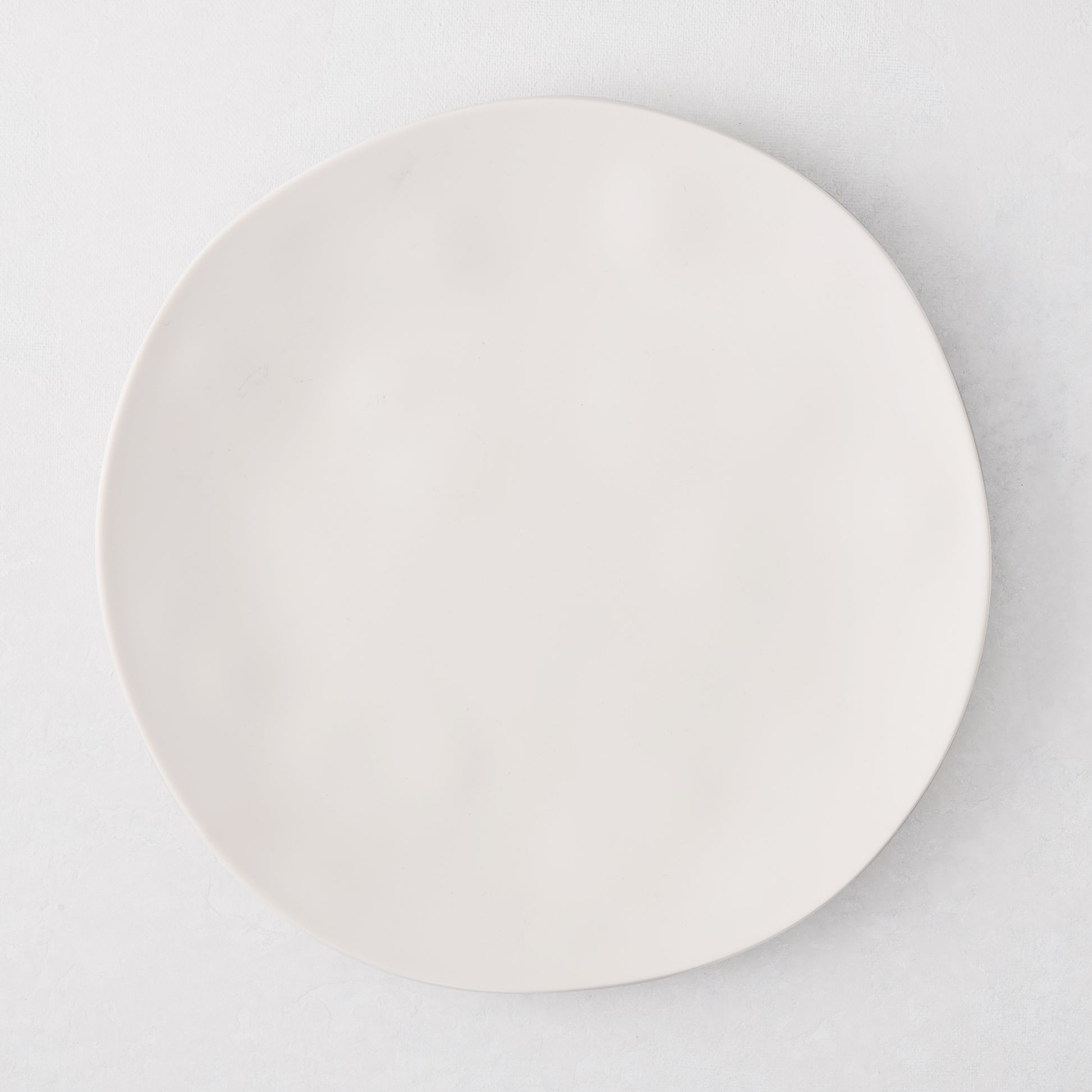 Laguna Melamine Appetizer Plate, off-white, 6.8"Dia, round, with subtle wavy edge.