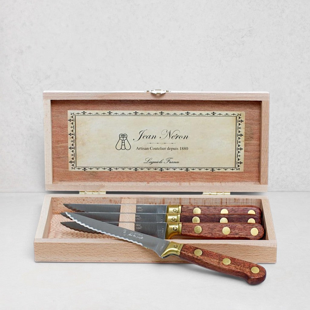 Set of 4 Laiton wood and brass stainless steel steak knives in an open wood box.