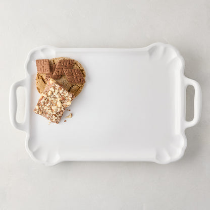 Large Alessia white ceramic handled serving platter with cookies, detailed edge.