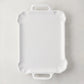 Large Alessia white ceramic handled serving platter with delicate scalloped edges.
