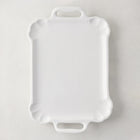 Large Alessia white ceramic handled serving platter with delicate scalloped edges.