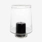 Large Antwerp clear glass hurricane candle holder with a black pillar candle inside.