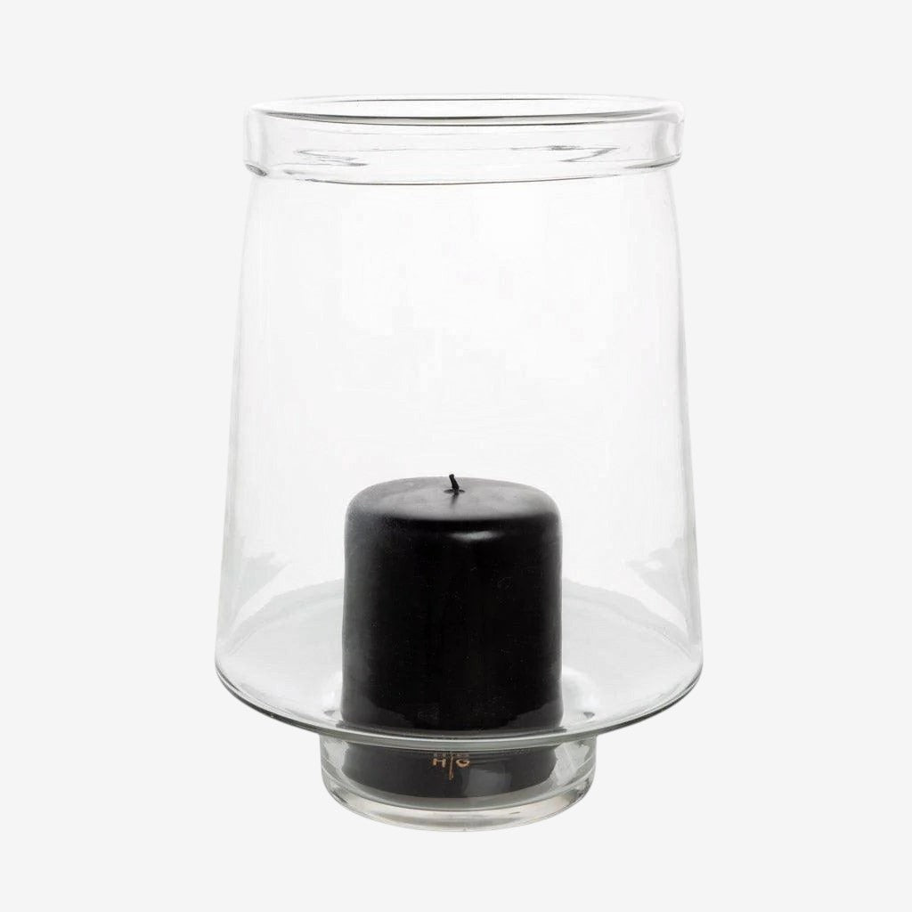 Large Antwerp clear glass hurricane candle holder with a black pillar candle inside.