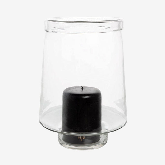 Large Antwerp clear glass hurricane candle holder with a black pillar candle inside.