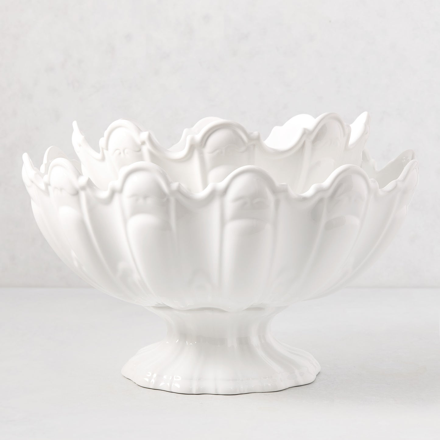 Large white ceramic scallop serve bowl, 17"Dia. x 9"H, with a decorative fluted design.