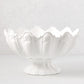 White ceramic scallop serve bowl, 17"Dia. x 9"H, with a fluted base and wavy rim.