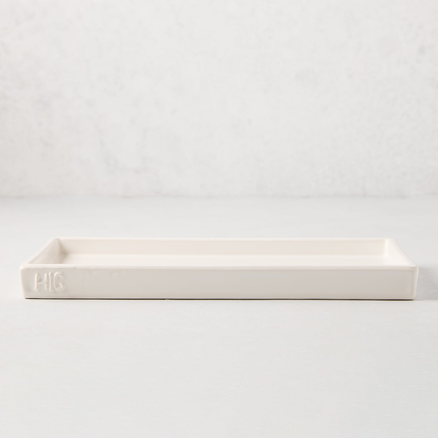 White ceramic HG Large Everyday Tray, 11"L x 5"W, with understated lip and HG monogram.
