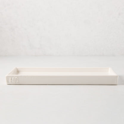 White ceramic HG Large Everyday Tray, 11"L x 5"W, with understated lip and HG monogram.