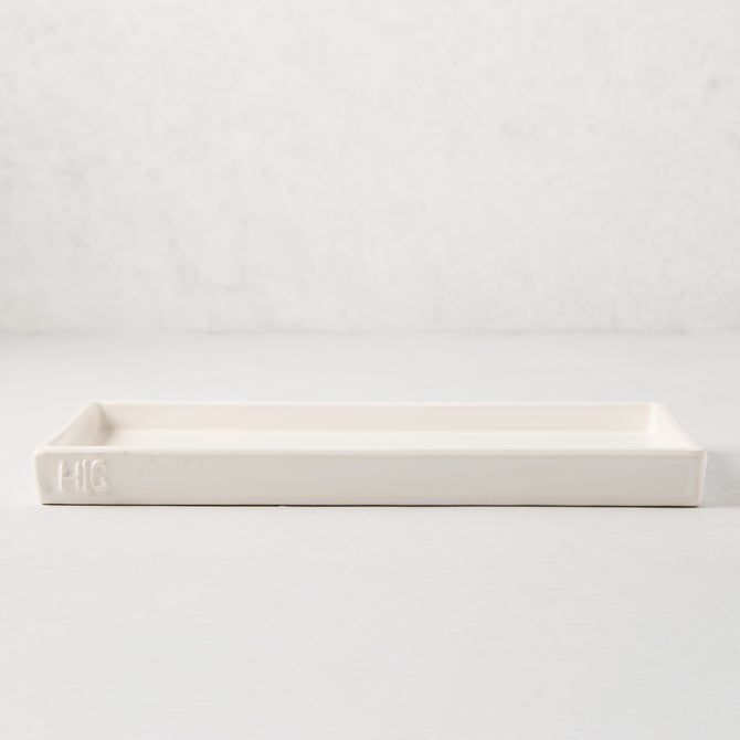 White ceramic HG Large Everyday Tray, 11"L x 5"W, with understated lip and HG monogram.