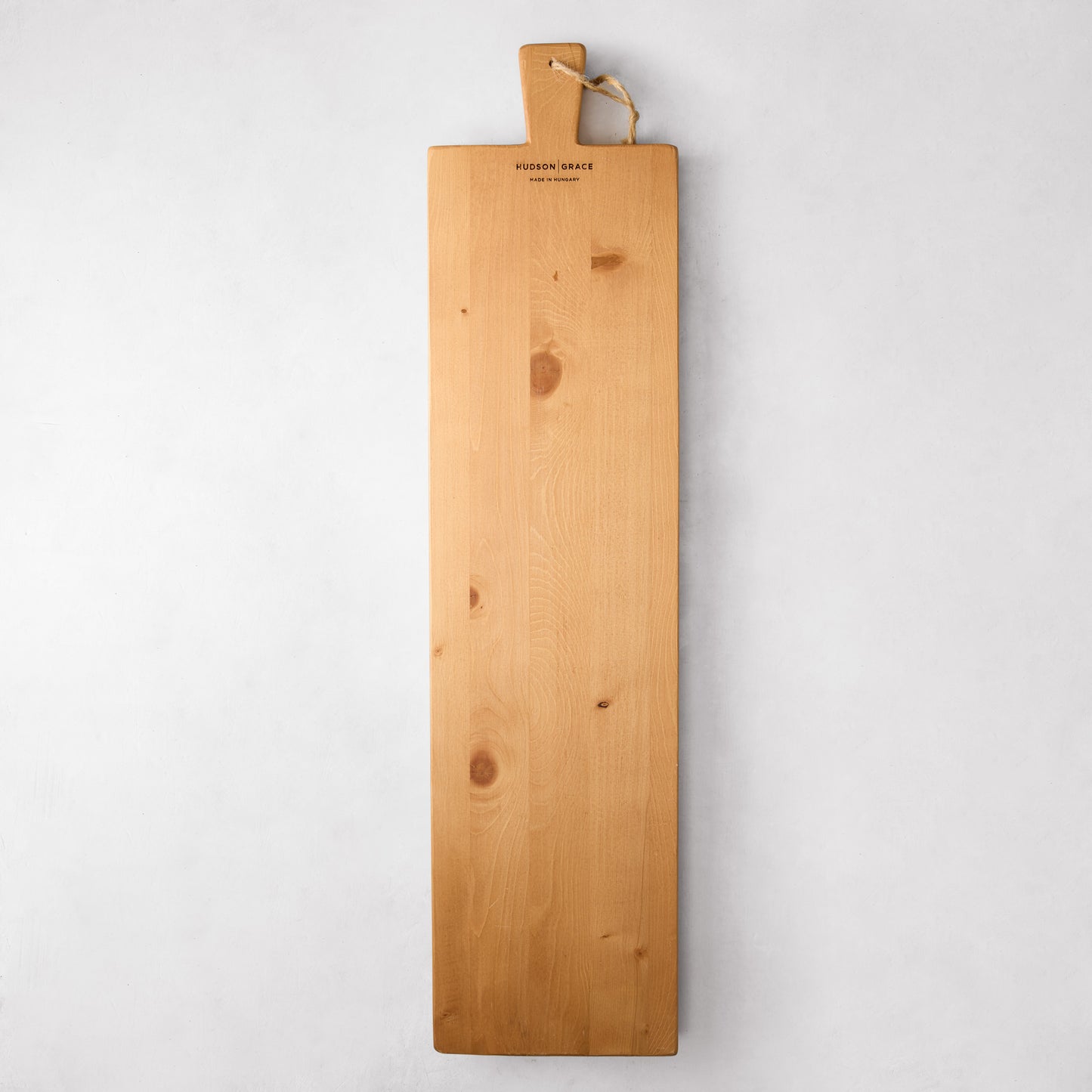 Long light brown European pine serving plank with handle and rope, "Hudson Grace" logo.