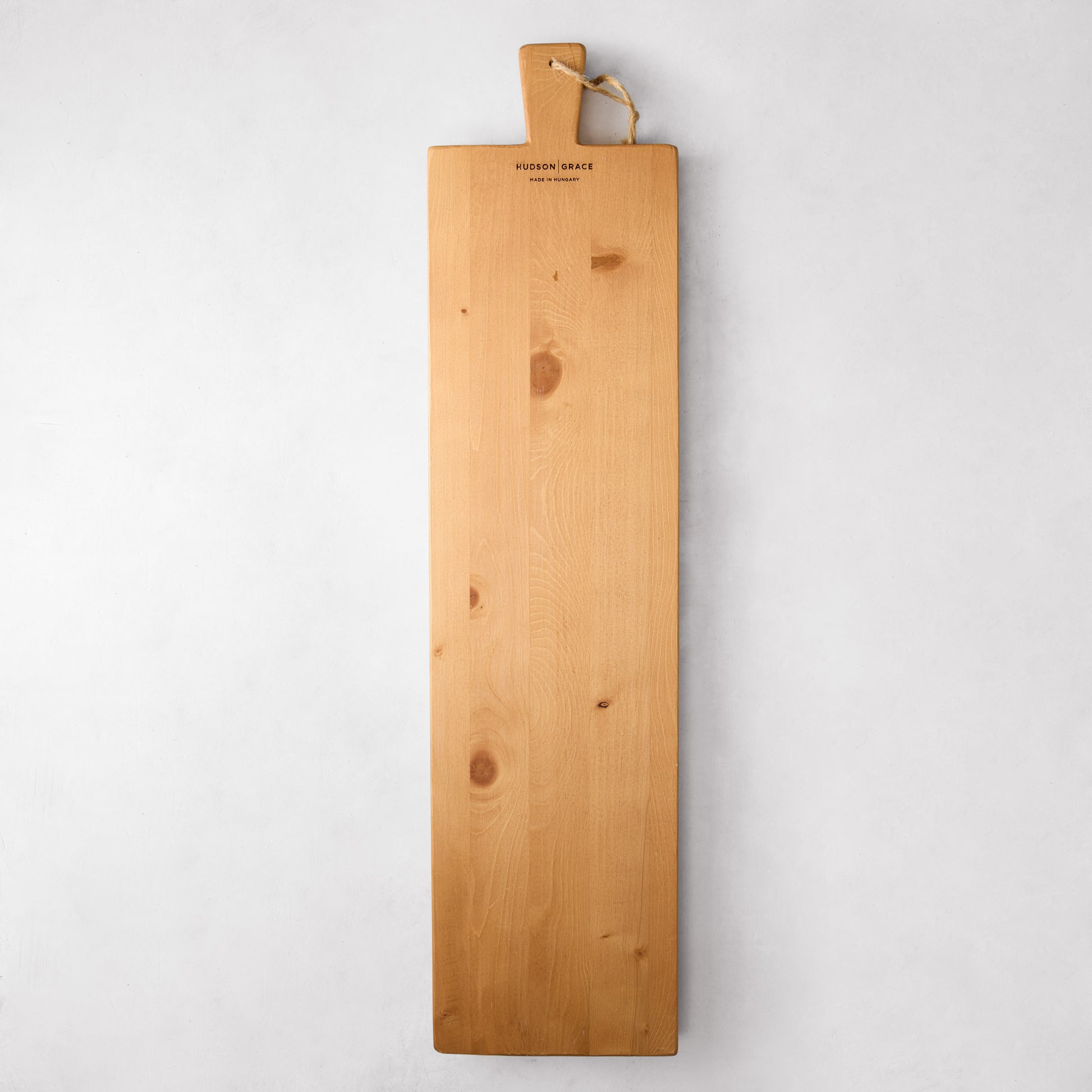Long light brown European pine serving plank with handle and rope, "Hudson Grace" logo.
