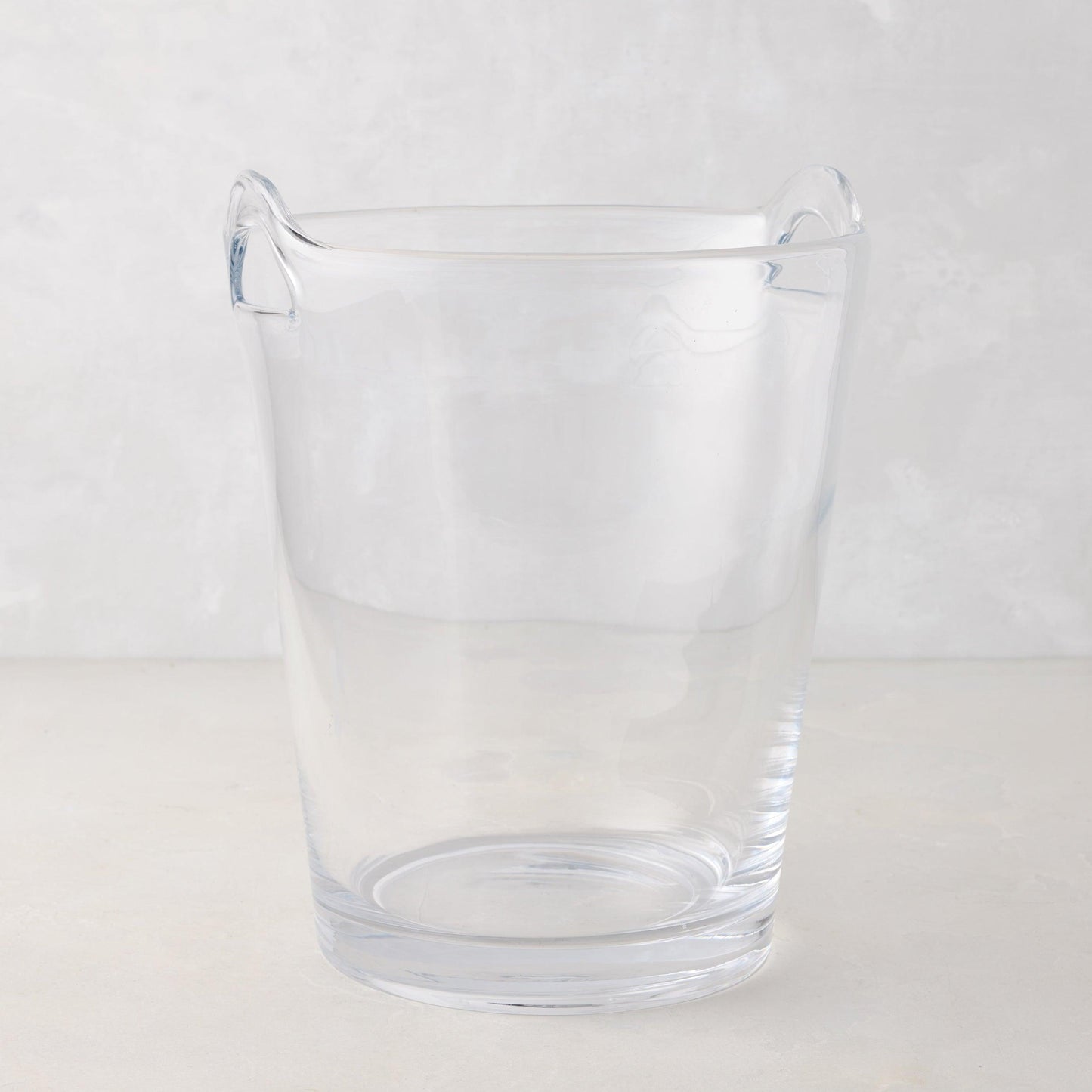 Large clear handblown glass ice bucket with two handles.