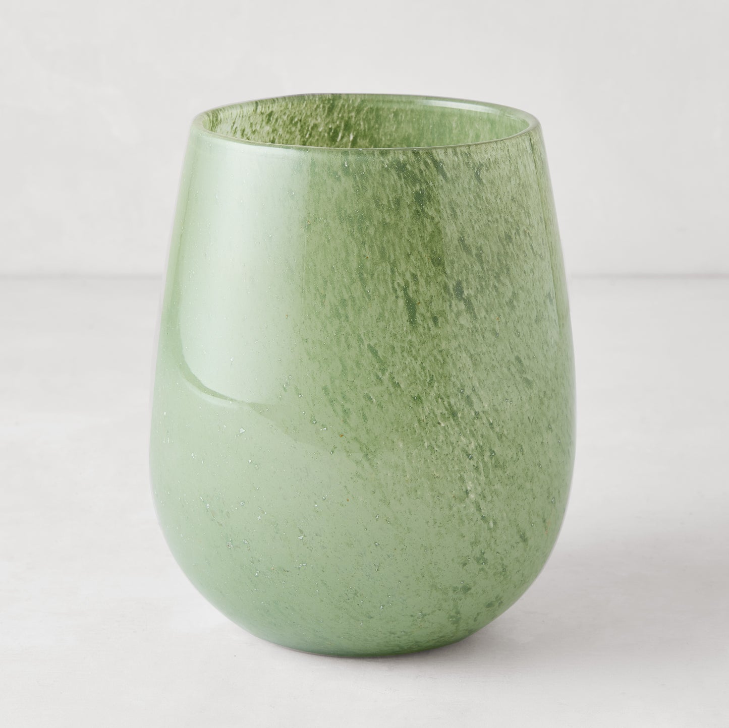 Large opaque green handblown glass barrel vase, 9"H x 7.5"W, with subtle texture.