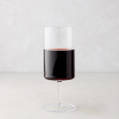 Large Hugo Stemmed Wine Glass, clear glass with red wine, modern sleek design.