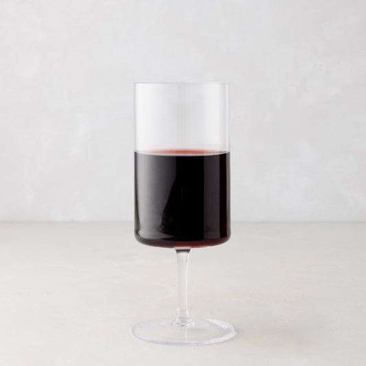 Large Hugo Stemmed Wine Glass, clear glass with red wine, modern sleek design.