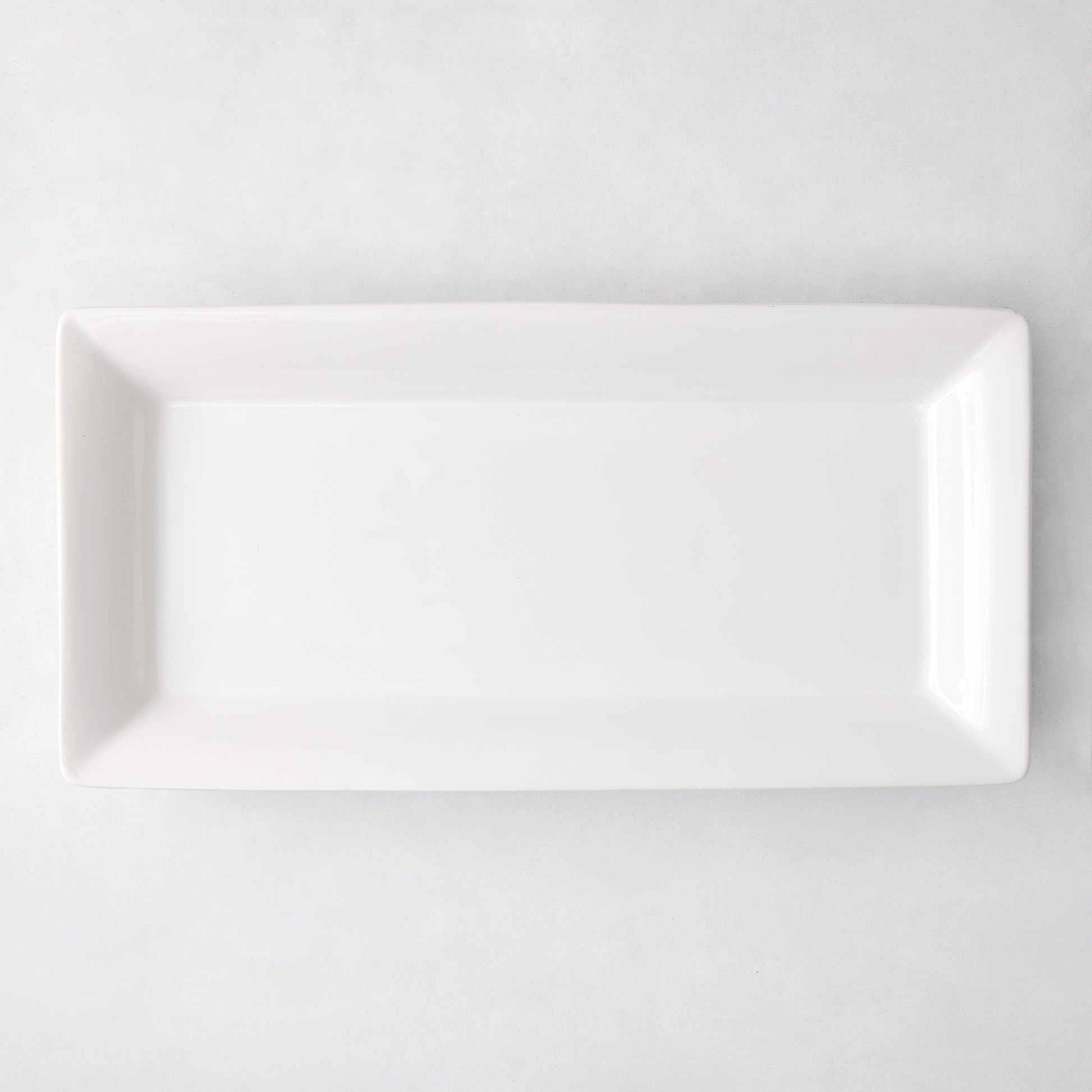 Large Lucca rectangular white ceramic serving platter with a sleek, modern edge.