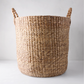 Large Montauk woven hyacinth round basket with braided handles.