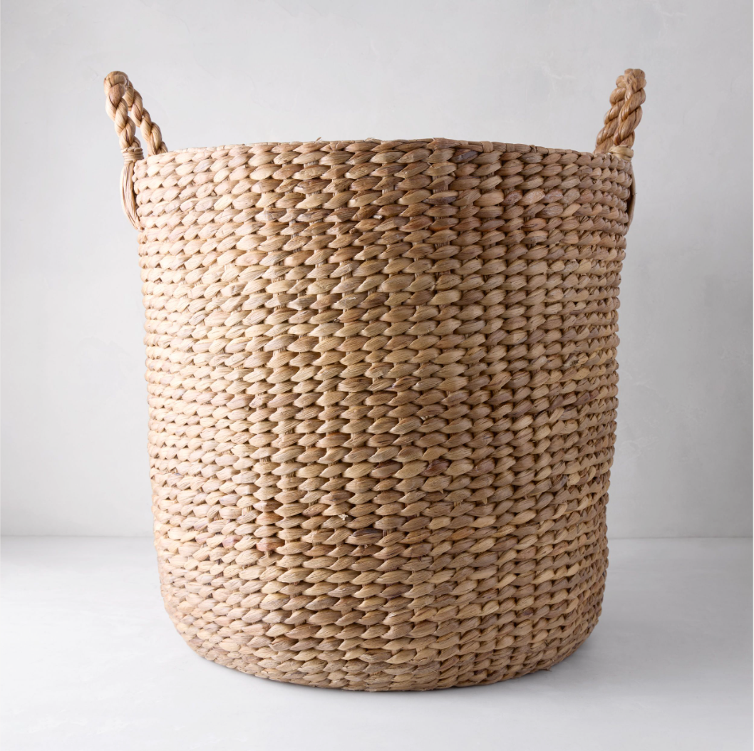 Large Montauk woven hyacinth round basket with braided handles.