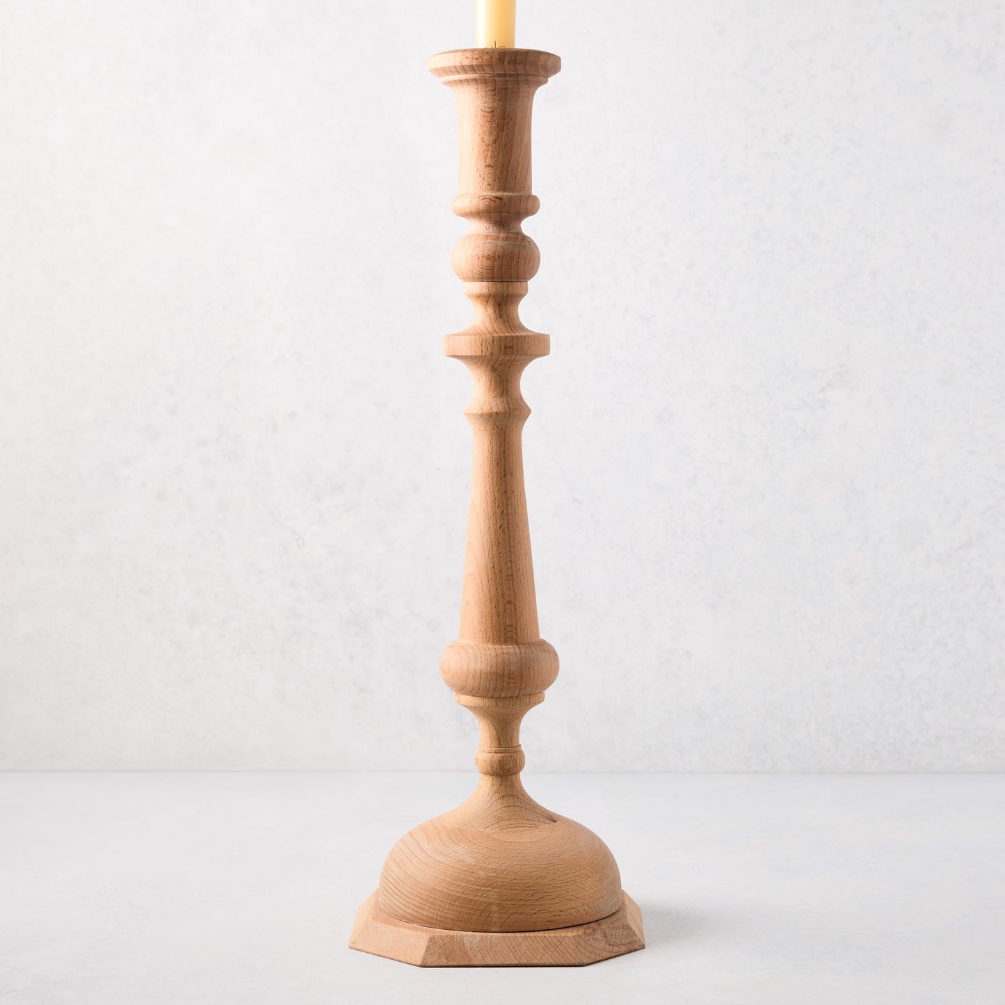 Large natural beechwood Georgian candlestick, 19"H, with a cream candle.